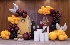 an arrangement of balloons and decorations for a harry potter birthday party