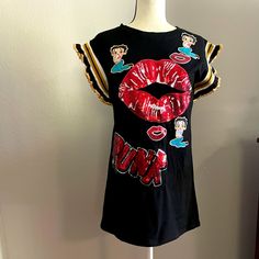 This Custom Made Shirt Dress Has Sequin Details On The Front With Lips, Betty Boop, Punk. It Is Detailed With Varsity Jacket Style Arms. Size Small. 17 In Across, 28 Length. Could Be Worn As A Long Short Or Tunic Depending On Your Height. Punk Style Short Sleeve Pre-shrunk Shirt, Pop Culture Graffiti Print Short Sleeve Tops, Red Punk Short Sleeve T-shirt, Varsity Jacket Style, Punk Graffiti Print Short Sleeve T-shirt, Punk Dress, Custom Made Shirts, Long Shorts, Betty Boop