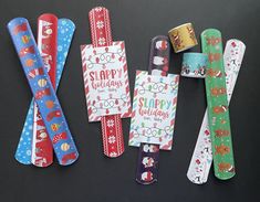 five different colored paper clips with christmas designs on them