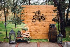 a wooden sign that says the martins on it next to some potted plants