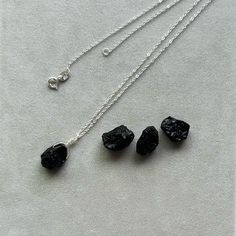 Embrace the protective energy of nature with our Natural Black Tourmaline Gemstone Necklace. This known for its grounding and shielding properties, Perfect for daily wear, this necklace not only enhances your style but also provides a sense of calm and balance. Each tourmaline stone is unique, showcasing its natural textures and deep black color. Whether you're looking for a meaningful gift or a special addition to your own jewelry collection, this necklace is a timeless choice for those who app Black Tourmaline Jewelry With Natural Stones, Black Tourmaline Necklace With Natural Stones, Chakra Heilung, Protective Energy, Raw Black Tourmaline, Chakra Racine, Body Energy, Tourmaline Pendant, Les Chakras