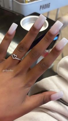 a woman's hand with white acrylic nails