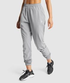 IN YOUR LOCKER
 In the gym or at home, the Training Woven Joggers are as versatile as they are comfortable. Featuring a high-waisted fit with a drawcord waist, a tapered leg and open pockets to each hip. 
- High rise fit
- Tapered leg
- Drawcord waist
- Open pockets
- Logo to left side
- Flattering seams on back
- 87% recycled polyester 13% elastane
- We've cut down on our use of swing tags, so this product comes without one
- Model is 5'6" and wears a size S
- SKU: B1A1D-GBC6 Athleisure Gym Pants With Drawstring, Athleisure Drawstring Pants For Gym, Sporty Gym Pants With Drawstring, Workout Pants With Drawstring, Athleisure Training Bottoms With Drawstring, Athleisure Gym Bottoms With Functional Drawstring, Athleisure Sports Pants With Drawstring, Athleisure Sweatpants With Drawstring For Workout, Athleisure Bottoms With Functional Drawstring For Gym