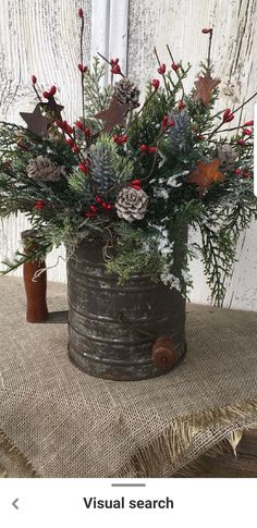 a wooden bucket filled with flowers and greenery on top of a burlock