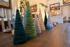 small christmas trees sitting on top of a wooden table