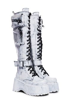 will have you winning every battle. These knee high combat boots have a vegan leather construction, heeled platform soles, zippered pockets on the sides, buckle strap details, adjustable lace-ups, and side zip closures. Cyberpunk Boots, Space Boots, High Combat Boots, All White Shoes, Knee High Combat Boots, Current Mood Clothing, Cage Dress, Goth Boots, Dr Shoes