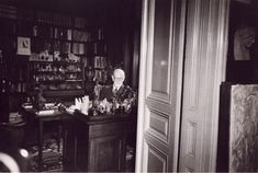 black and white photograph of an old man sitting at his desk