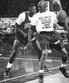 two men are playing basketball on the court