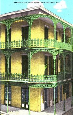 an old building with green balconies on the top floor and balcony railings