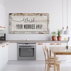 a kitchen with an old sign hanging on the wall above the stove and table in front of it