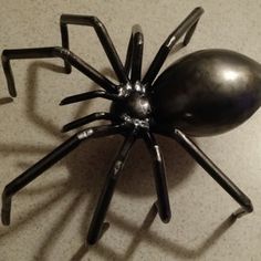 a metal spider sculpture sitting on top of a table