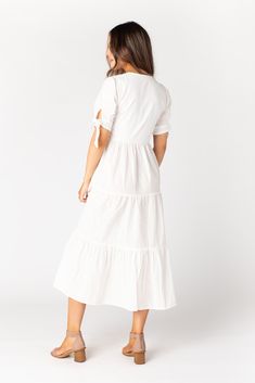 Lightweight woven swiss dot midi dress Notched neckline Short sleeves with ties Multiple gathered tiers Bodice is lined Fabric content - Cotton - Dry clean only recommended Maternity Pictures Dress, Proposal Dress, Prettiest Sunset, Wedding Getaway, White Tiered Dress, Getaway Dress, Called To Surf, Tie Sleeve Dress, Easter Dresses