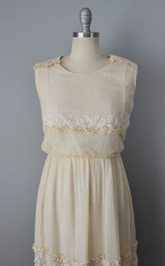 "Exquisite Edwardian dress in cream Silk Georgette with white lace inserts on the shoulders, across the bodice, and skirt. Beautiful details such as ruffled trim and pin tucking. Custom made with intricate snap and hook closures and lined in white silk. A slight blouson effect on the sleeveless top and gathering at the waist of the two layered skirt. Size- Small Bust - 34\" Waist - 25\" w/ room to add an inch onto the inner waist cincher. Hips - 48\" Length - 40\" Label: none Condition: Excellen Off White Lace Dress With Ruffles, Summer Wedding Dress With Contrast Lace, Vintage Daywear Dress With Lace Sleeves, Vintage Lace Sleeves Dress For Daywear, Vintage Dress With Lace Sleeves For Daywear, Cream Dress With Lace Patchwork For Garden Party, Cream Dresses With Lace Patchwork For Garden Party, Cream Lace Dress With Lace Collar For Spring, Sleeveless Lace Top Dress For Daywear