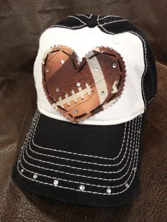 a black and white baseball cap with a heart cut out of it