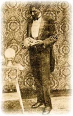 an old photo of a man in a tuxedo standing next to a wall