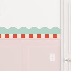 the door is open and there is a pink wall with an ocean scene on it