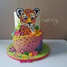 a decorated cake with a leopard on top