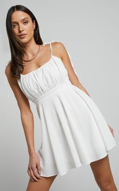 Get ready to turn heads in the Aziah Mini Dress! This stunning white dress features tie shoulder straps and a ruched bodice for an effortlessly chic look. Made from high-quality polyester, this A-line fit and flare dress is perfect for both casual daytime outings and party nights. The sleeveless design adds a touch of elegance, while the straight mini length keeps it fun and flirty. Embrace your inner fashionista with the Aziah Mini Dress - it's time to slay all day!Product Details:A-line dress Slay All Day, Bodice Dress, Straight Neckline, Ruched Bodice, Dress Silhouette, Flowy Skirt, Tie Dress, Casual Party, Fit And Flare Dress