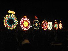 a group of people standing in front of colorful lights