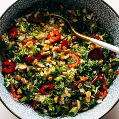 a salad in a bowl with a spoon on the side, ready to be eaten