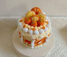 an orange and white crocheted cake on top of a table