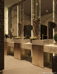 a bathroom with two sinks, mirrors and lights on the wall above them is shown