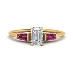 an emerald and pink tourmaline engagement ring in yellow gold with two diamonds on each side