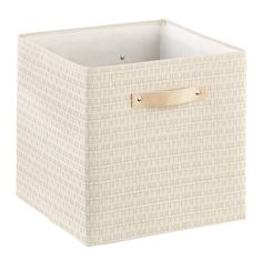 a white basket with gold handles on the bottom and sides, filled with fabric material