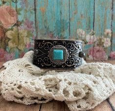 v'¯) .`*.¸.*' ❤ CONCHO COLLECTION ❤ ¸.*'.*'¨) ¸. (¸.*'(¸.*' (¸. Hand Painted Leather My leather concho cuff bracelets will add a rustic feminine touch to your look! Each made from tooled leathers & beautifully detailed conchos. Filigrees and rivets add dimension. They can be dressed up or down to compliment any outfit. Buy it ---- Wear It----Make it your own! This DESIGN ~ ❤ Pretty faux-turquoise & silver square concho. ❤ Tooled leather, painted black. Hand rubbed and distressed adds rustic char Adjustable Western Cuff Bracelet For Festivals, Adjustable Western Style Cuff Bracelet For Festivals, Adjustable Western Style Festival Cuff Bracelet, Western Style Adjustable Cuff Bracelet For Festivals, Western Patina Cuff Bracelet Gift, Adjustable Western Cuff Bracelet With Patina, Bohemian Concho Cuff Bracelet As Gift, Vintage Turquoise Cuff Bracelet For Festival, Turquoise Vintage Cuff Bracelet For Festival