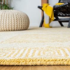 a yellow and white rug on the floor