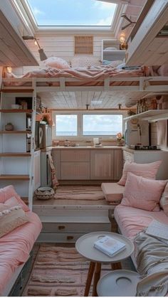 the interior of a tiny house with pink furniture and decor on the walls, windows, and ceiling