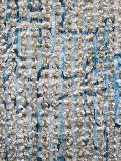 close up view of an area rug with blue and white stripes