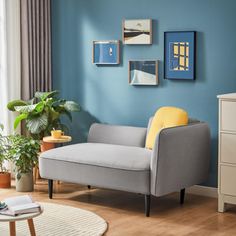 a living room with blue walls and white furniture in the corner, including a gray chair