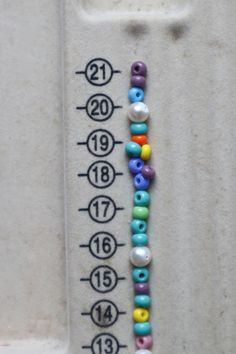 a measuring tape with beads on it next to the numbers for each child's birth