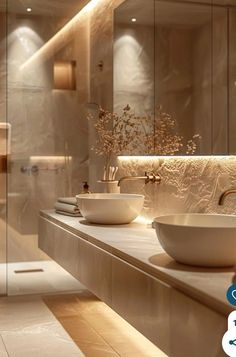 a bathroom with two sinks and a large mirror in the wall next to each other