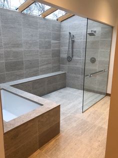 a bathroom with a walk in shower next to a bath tub