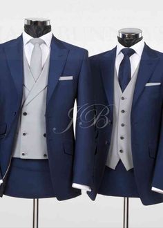 two suits are shown on mannequins, one is blue and the other is white