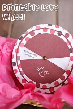 a pink and brown paper plate sitting on top of a wooden table