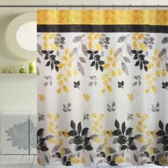 a shower curtain with yellow and black flowers on it