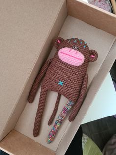 a crocheted stuffed animal in a box