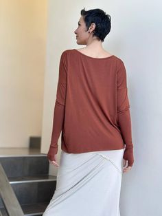 Boyfriend Top Our long sleeve Boyfriend Top is about to become your everyday go-to top. It has a relaxed fit and is made from a soft lightweight rayon jersey that drapes easily on all figures. This tee can also double as a shrug, making it an ideal travel top. One Size (O/S) Colors This long sleeve jersey is available in these colors: Steel Copper Teal Black Jam Navy Wine Canal Blue Plum Learn MoreInterested in learning more about our plant-based fabrics made in small batches and our jewel-tone Versatile Long Sleeve Top With Soft Stretch, Versatile Soft Stretch Long Sleeve Top, Stretch Modal Long Sleeve Tops, Long Sleeve Modal Tops For Fall, Versatile Long Sleeve Top With Thumbholes For Fall, Oversized Fine Knit Long Sleeve Top, Versatile Stretch Long Sleeve Top For Everyday, Fine Knit Modal Long Sleeve Tops, Versatile Relaxed Fit Fine Knit Tops