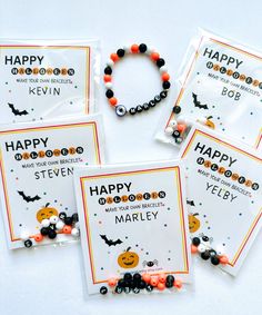 four halloween bracelets are shown on the table