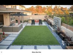 an outdoor patio with grass and seating area