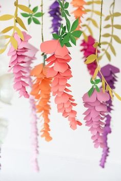 paper flowers are hanging from the ceiling