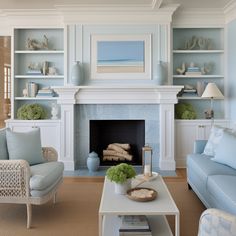 a living room filled with furniture and a fire place in front of a white fireplace