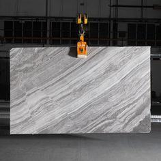 a white marble counter top in an industrial building with yellow signs on the wall behind it