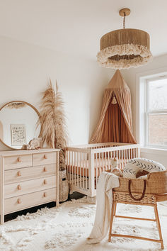 a baby's room with a crib, dresser and bed