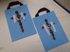 two pieces of paper are cut out to look like the letters m and n on blue bags