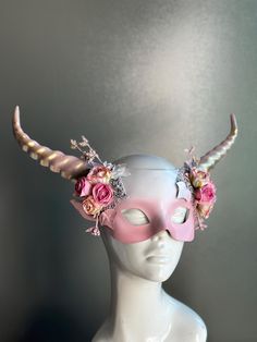 Women's mythical long horn masquerade mask in pink with roses. This Mask can be customized to match your costume colors, select the custom option!  C U S T O M I Z A T I O N Get in touch for custom orders! S I Z E  Adult size. S H I P P I N G -  Processed same day or within 24 hours.  1-2 day guaranteed delivery, add item to cart, click shipping tab for rates.  Pls leave a check out note with your need date & contact number  Msg for delivery time frames (Include your state/country) C O N T A C T Pink Costume Accessories For Cosplay Party, Pink Costume Accessories For Cosplay Party Events, Pink Themed Costume Accessories For Costume Party, Pink Costume Hats And Headpieces For Halloween, Pink Costume Accessories For Carnival, Pink Carnival Costume Accessories, Horned Mask, Horn Headpiece, Pink Headpiece