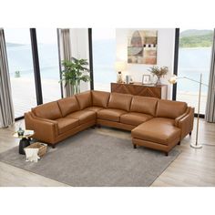 a brown leather sectional sofa sitting on top of a rug